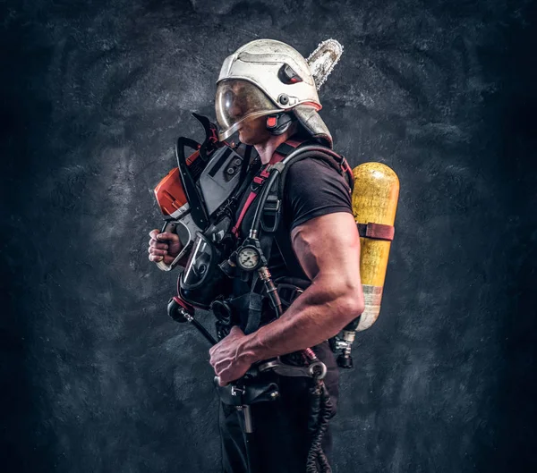 Portrait of muscular man with chainsaw and respirator — Stock Photo, Image