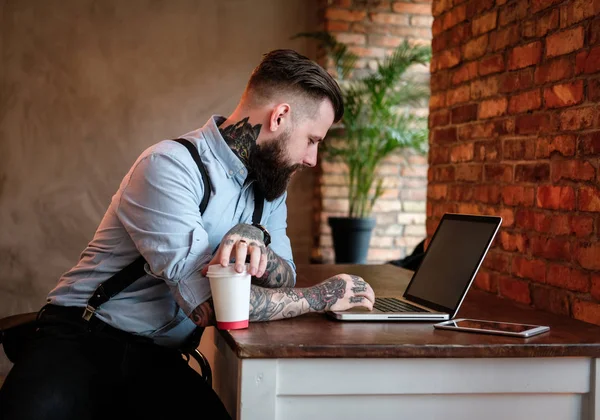 Portrait of bearded man with tattoes on his arms — Stock Photo, Image