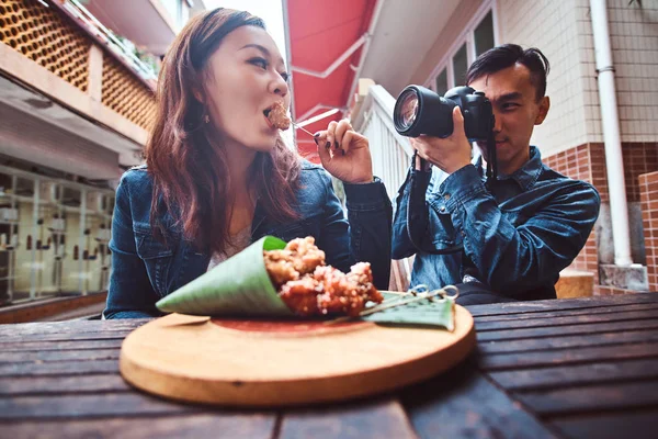 Mladí asijští manželé si užívají čínského jídla a fotografování — Stock fotografie