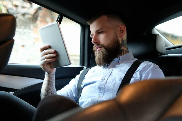 Portrait of bearded man with tattooes on his arms — Stock Photo, Image