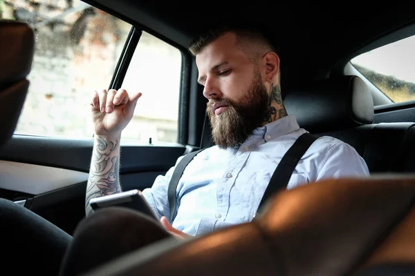 Parrakkaan miehen muotokuva, jolla on tatuointeja käsivarsissa — kuvapankkivalokuva