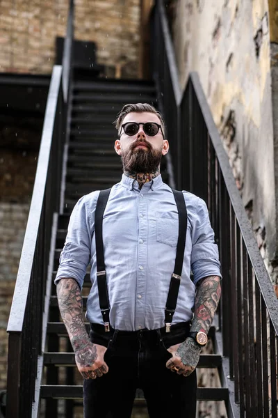 Portrait of bearded man with tattooes on his arms — Stock Photo, Image