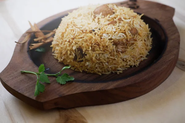 Indian traditional dish with rice and coriander leaf on wooden tray — Stock Photo, Image