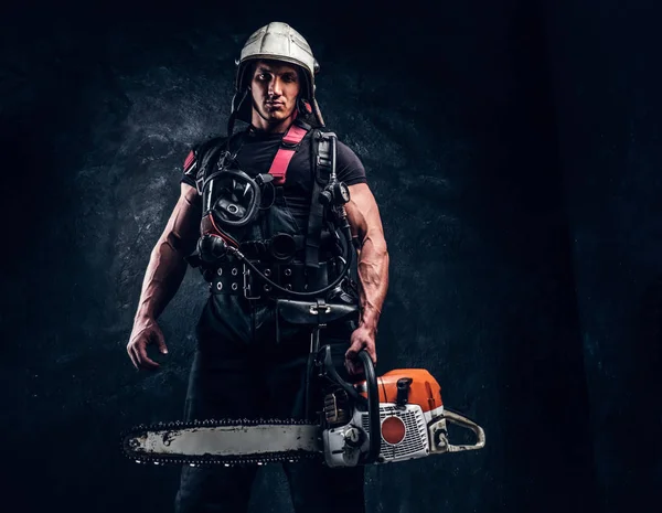 Portrait of muscular man with chainsaw and respirator — Stock Photo, Image