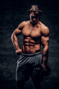 Çekici kaslı adam dambıl ile poz