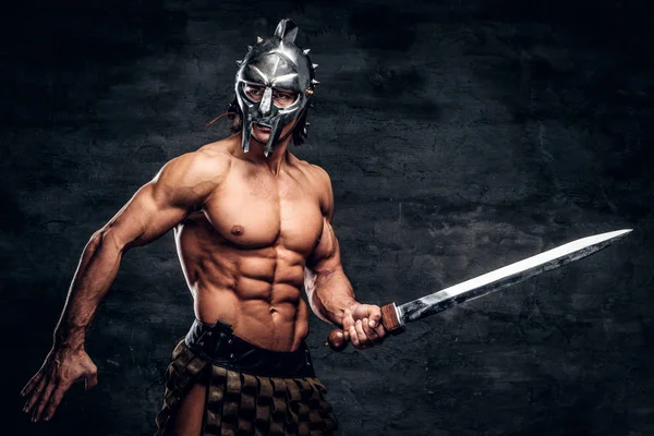 Strong gladiator with sword in his hands — Stock Photo, Image