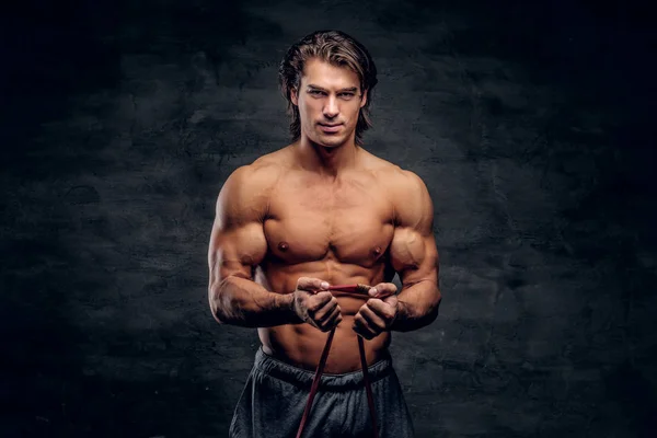 Beatiful smiling bodybuilder is doing exercises with rubber — Stock Photo, Image