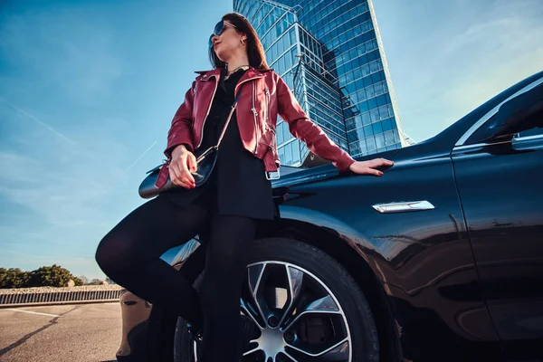 Ung attraktiv kvinna kyler i ljusa soliga dag bredvid sin bil — Stockfoto