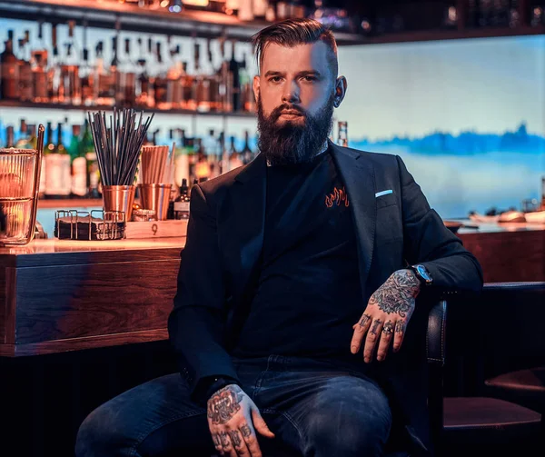 Attractive brutal man is sitting near bar counter — Stock Photo, Image