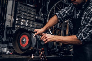 Repairmaster meşgul bucycle atölyesinde takım tezgahı ile çalışıyor.