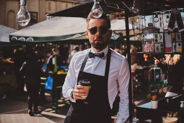 Inteligente barista en vasos tiene un descanso en su propio coffeeshop . — Foto de Stock