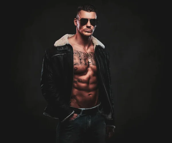 A macho stylish man on a dark background. — Stock Photo, Image