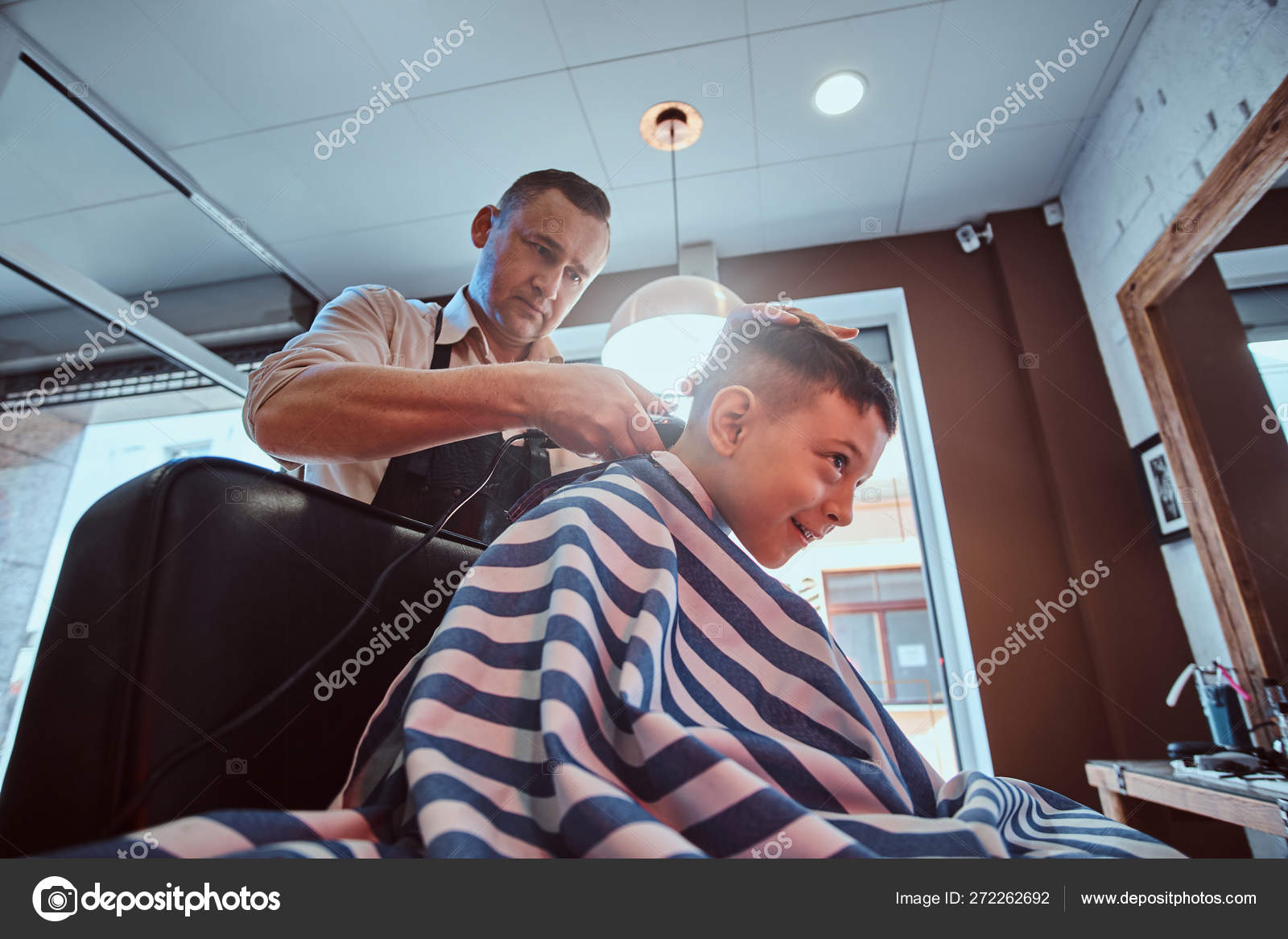 School Boy Is Enjoing The Process Of Haircut From Expirienced