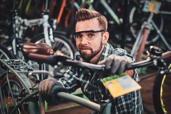 Усердный человек проверяет велосипеды цепи для клиентов . — стоковое фото
