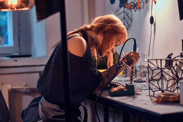 Atraktivní žena pájedla ve svém vlastním řemeslním studiu. — Stock fotografie