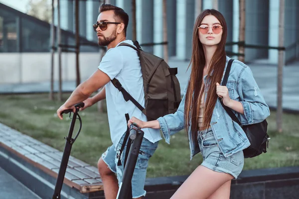 Young couple is enjoying electro scooters riding — 스톡 사진