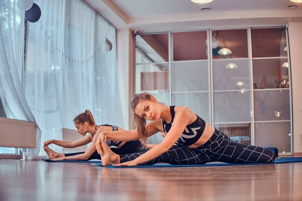 Gils yoga sınıfında birlikte egzersiz yapıyor