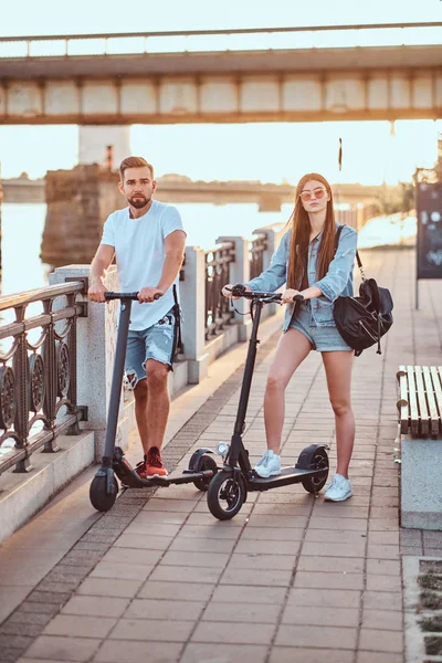 Young couple is enjoying electro scooters riding — 스톡 사진