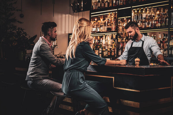 Posh couple is celebreting special date at the bar