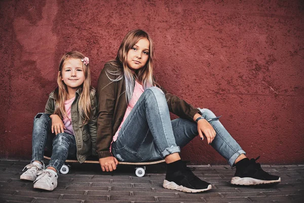 Porträt zweier hübscher Schwestern mit Skateboard — Stockfoto