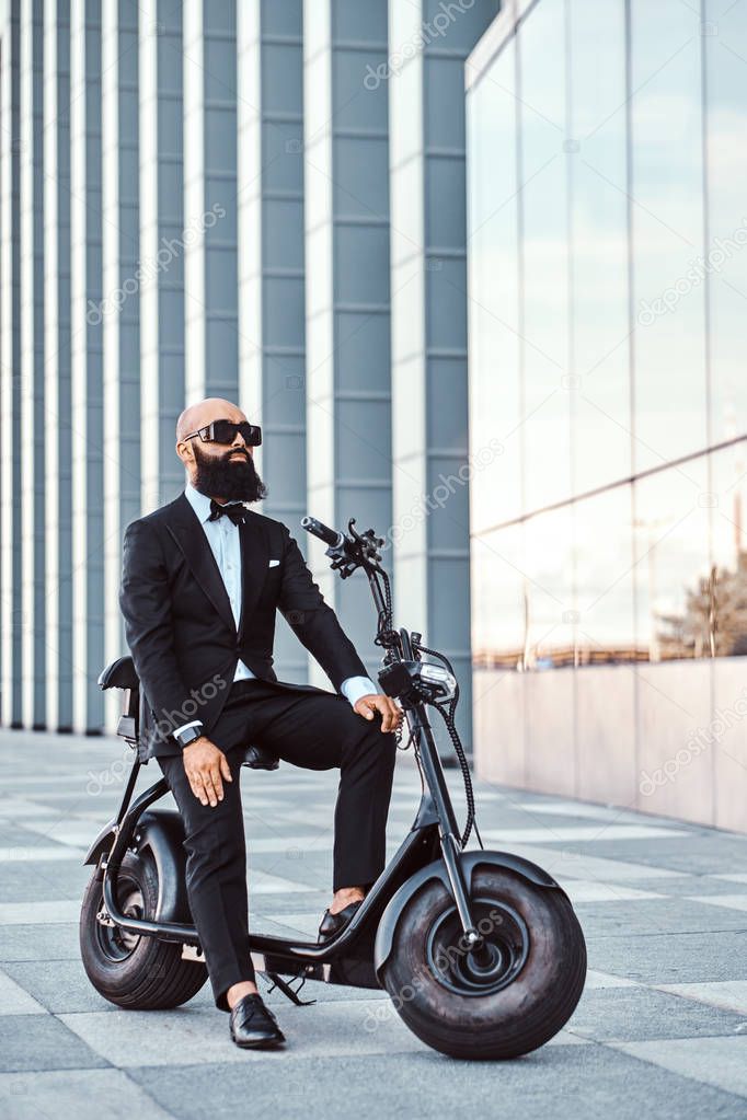 Modern man is sitting on his new electro scooter