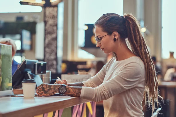 Portrait of young creative girl with dreadlocks and sketch pad — Stock Photo, Image