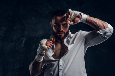 Portrait of handsome bearded man in boxing gloves clipart