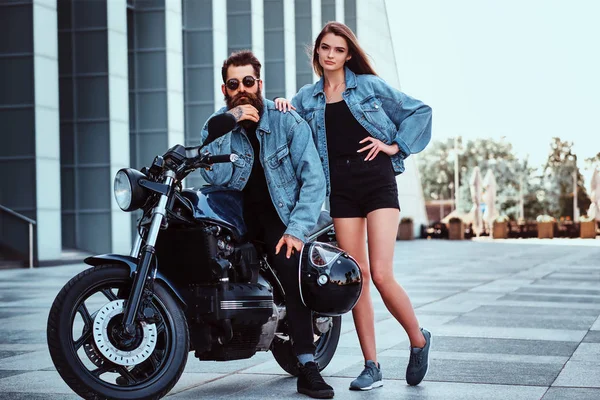 Retrato de pareja en chaquetas de mezclilla con moto —  Fotos de Stock