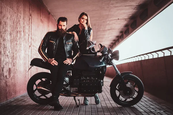 Portrait on the couple in the tunnel with motorbike — Stock Photo, Image