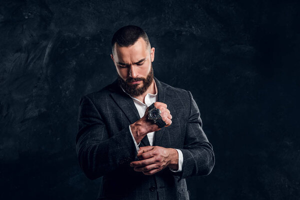 Portrait of elegant businessman at dark photo studio