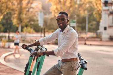 Adam cep telefonunu kullanarak elektro scooter için ödüyor