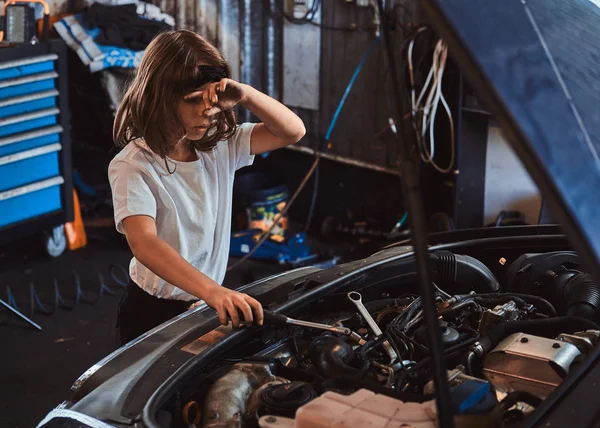 Portrait of nice little girl at auto service workshop — Stock Photo, Image