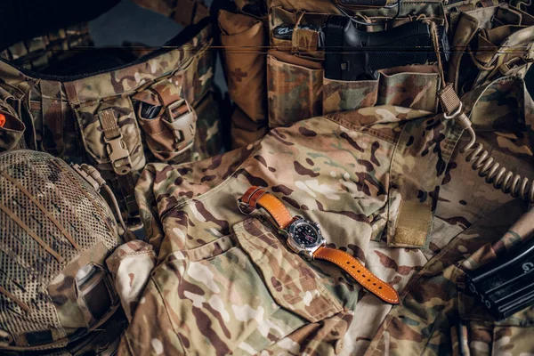 Nice watch with military uniform on the table