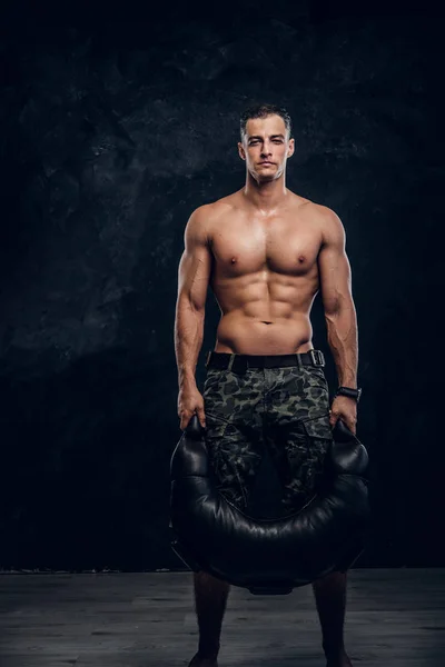 Portrait of shirtless muscular man over dark background — Stok Foto