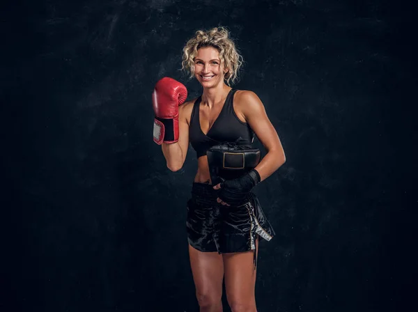 Portrait of expirienced female boxer in photo studio