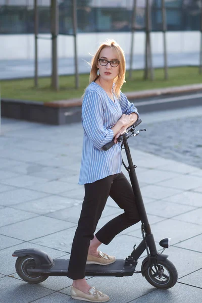 Mujer joven está disfrutando de montar en su nuevo scooter —  Fotos de Stock