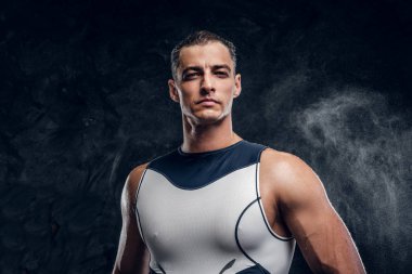 Koyu renk fotoğraf stüdyosunda dalış kıyafeti giymiş çekici adam