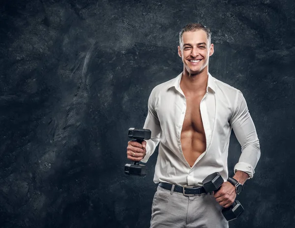 Attractive man in white shirt at dark photo studio — Stock Photo, Image