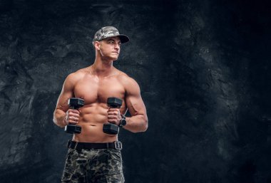 Koyu arka plan üzerinde gömleksiz kaslı adam portresi