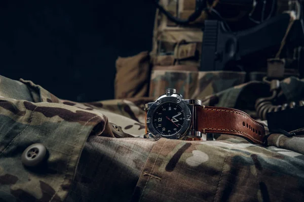Nice watch with military uniform on the table