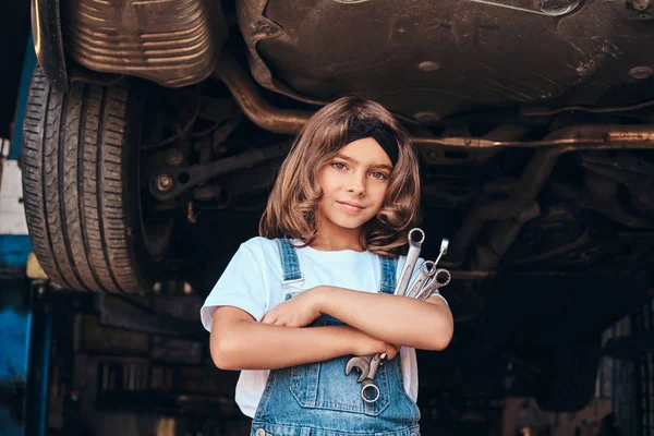 Porträt eines süßen kleinen Mädchens beim Autoservice — Stockfoto