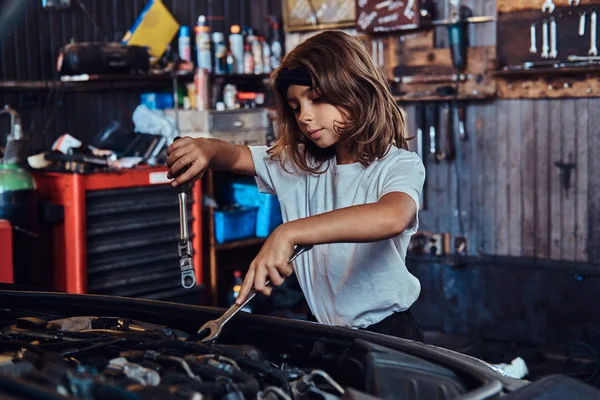 Portrait of nice little girl at auto service workshop — Stock Photo, Image
