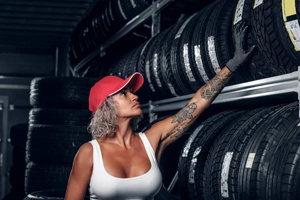 Woman is looking for right tyre