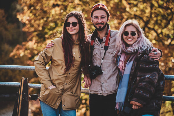 Beautiful people surrounded with yellow trees