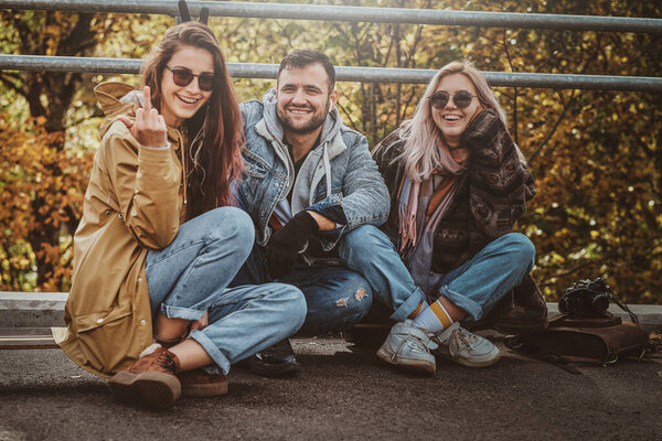 Group of people enjoy sunny autumn day in the park