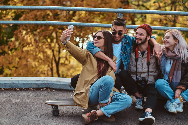 Group of people enjoy sunny autumn day in the park