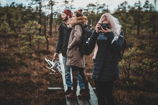 Girl is taking a photo using her photo camera