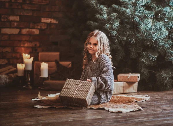 Portrait of cute little girl near christmas tree — Stock Photo, Image