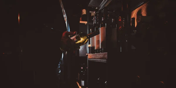 Elegant man in suit at wine cellar with bottle of wine — Stock Photo, Image