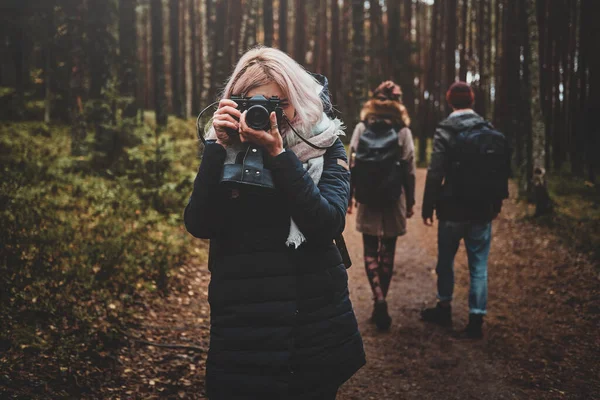 Girl is taking a photo using her photo camera